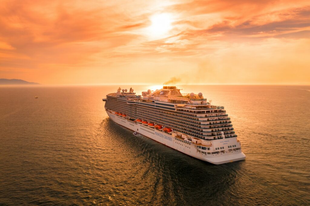 a white cruise ship on the water during sunset